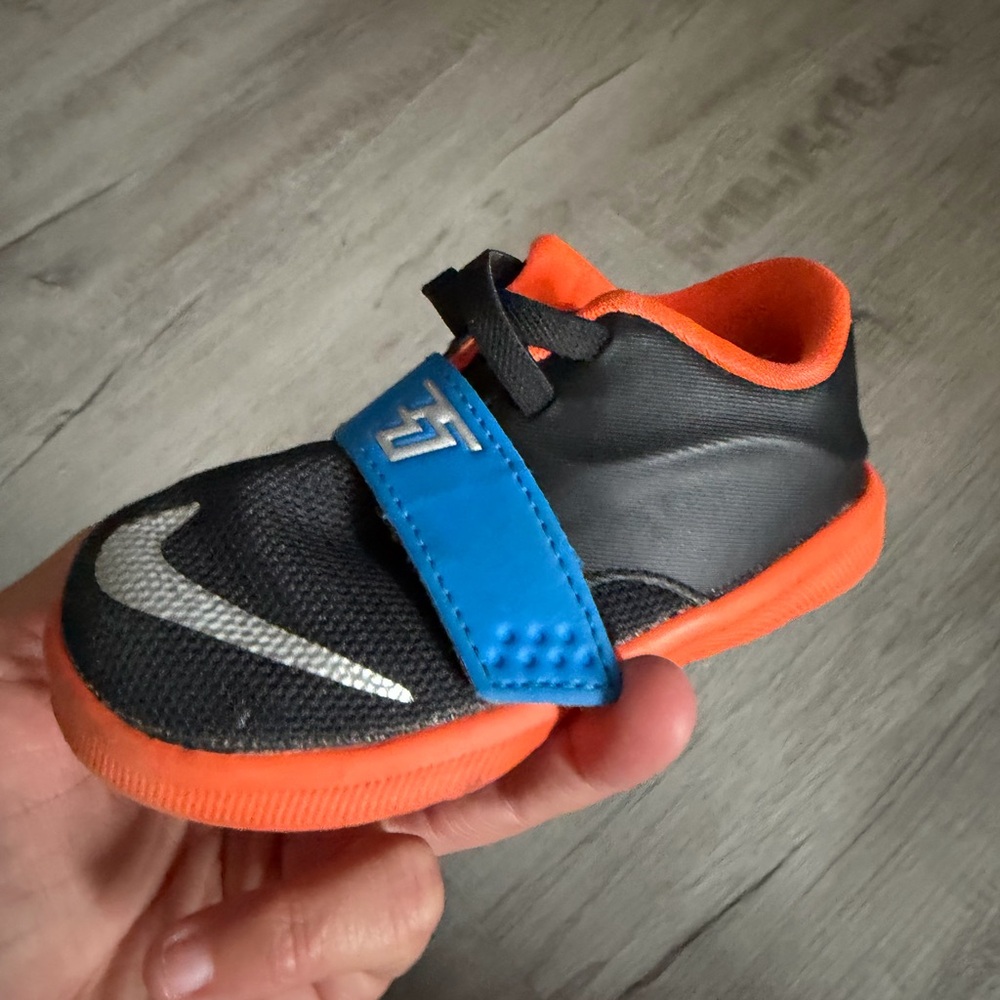 Nike Kids Black, Orange, and Blue Sneakers